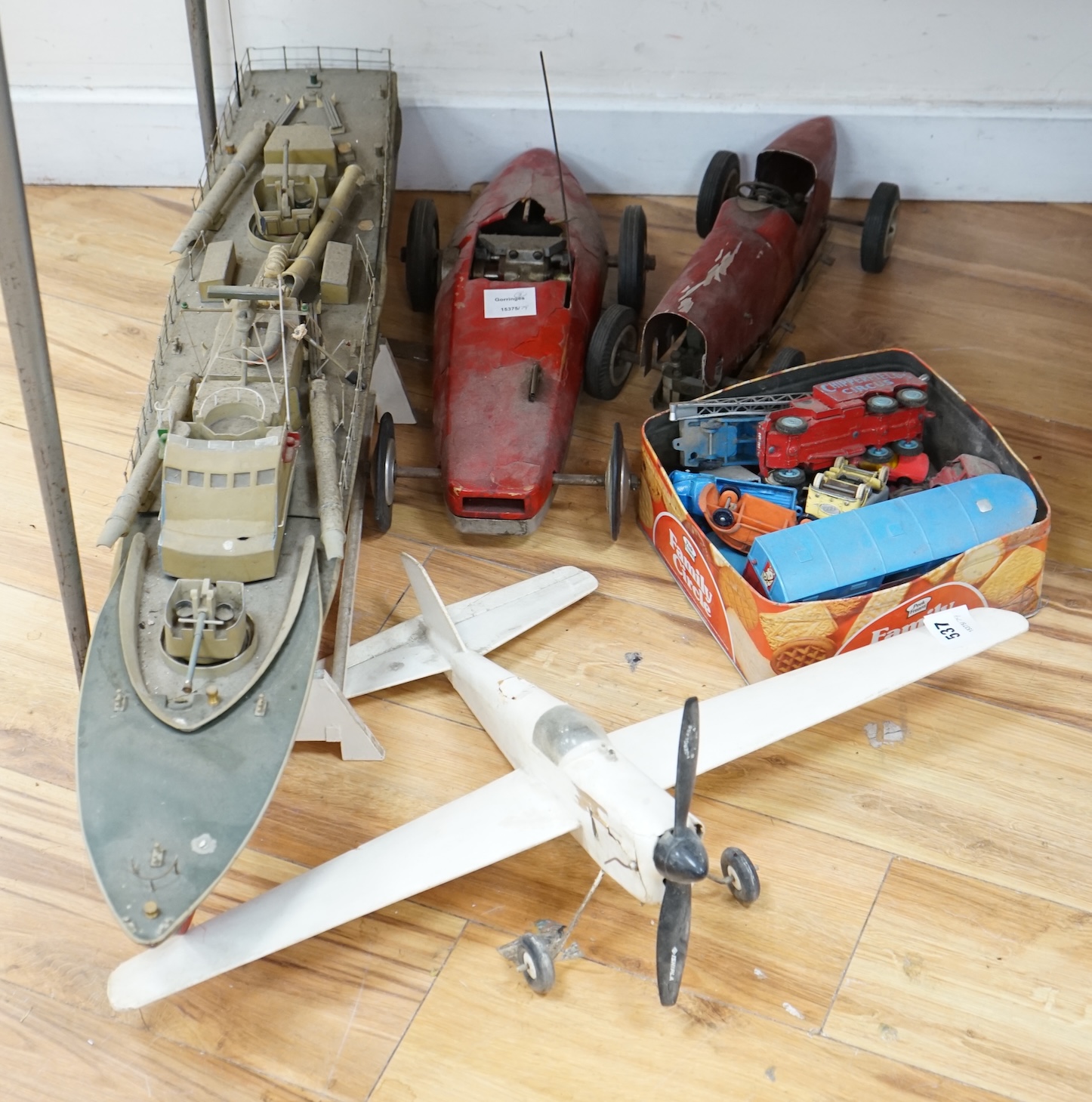 Two tinplate model racing cars, a model aeroplane, battleship and other various cars. Condition - poor